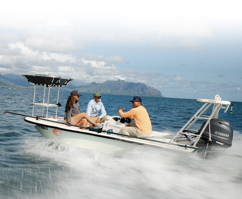 Three people on a boat, speeding off into the ocean.