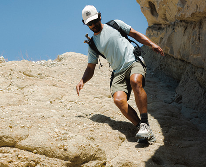 A hiker scrambling down rocks