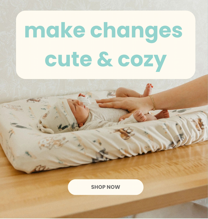Three changing pad covers with floral and leaf patterns.