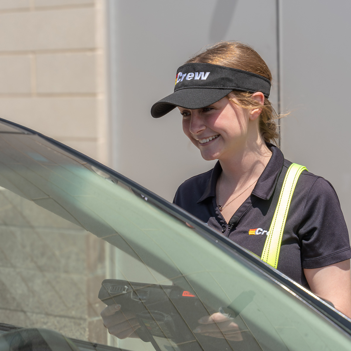 A smiling Crew Carwash team member