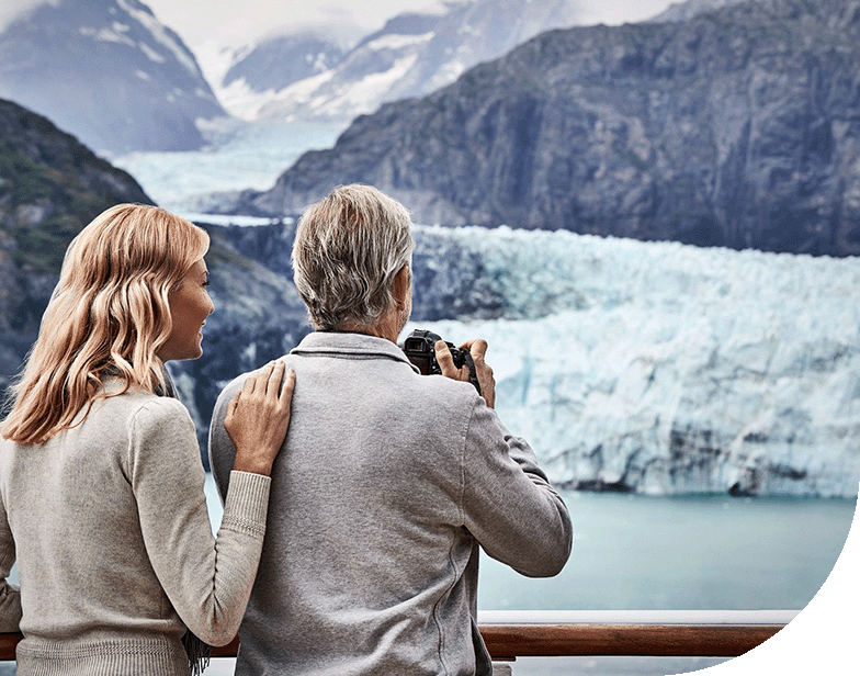 A couple observerves the massive glaciers at Glacier Bay National Park, Alaska