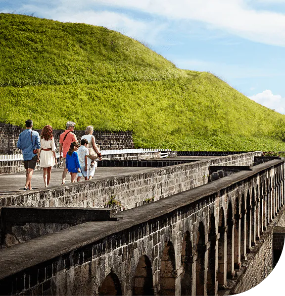 Family of six walking along old fortress in St. Kitts.