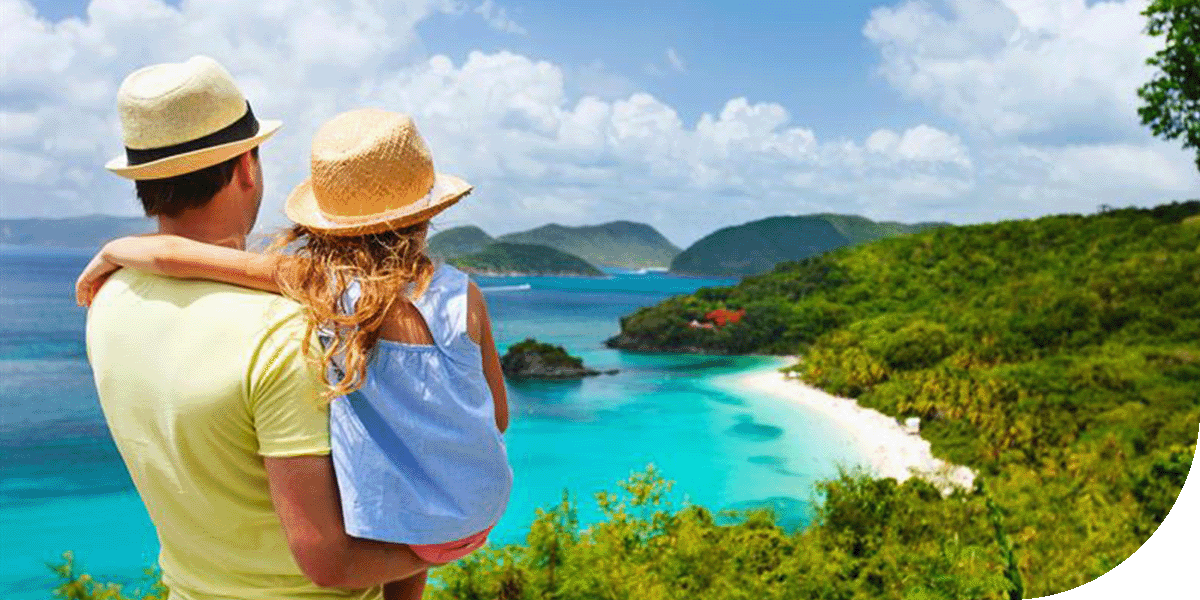 A father takes in the ocean scenery with his daughter in St. Thomas, Caribbean.
