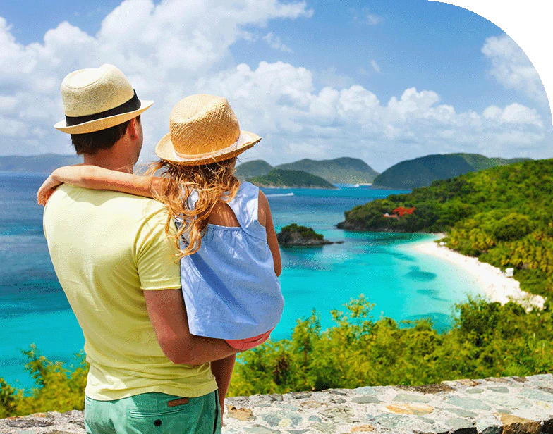 A father and daughter look out onto the blue ocean waters of St. Thomas, Caribbean