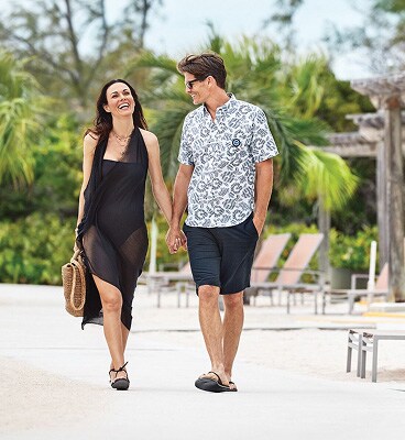 Two travellers stroll along Princess Cays, Bahamas.