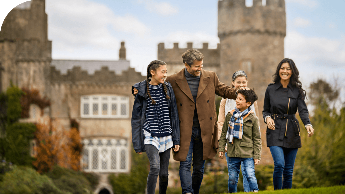 Family of five in front of castle in Dublin, Ireland.