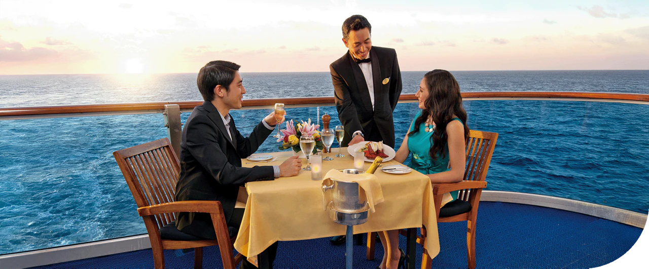 A couple dines on the balcony of a Princess cruise ship in the Caribbean.