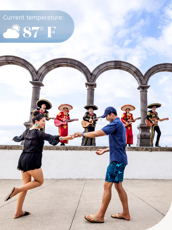 Couple dancing with a mariachi band in the back