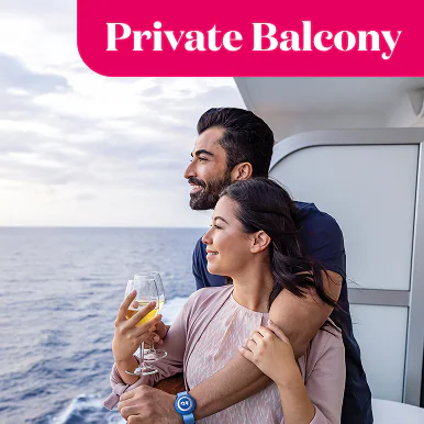 Private balcony. Couple standing on their balcony overlooking the water.