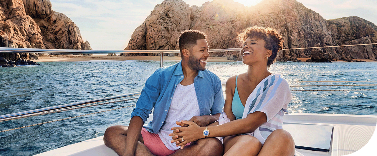 Two travellers on a boat in the waters of Cabo San Lucas, Mexico.