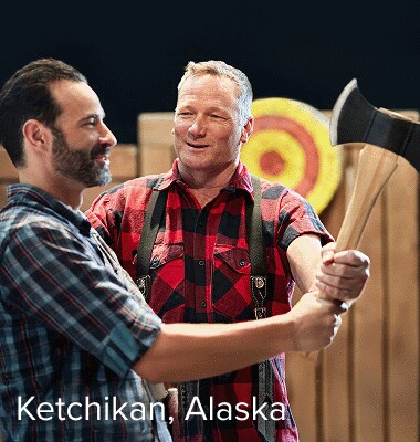 A man practices axe throwing.