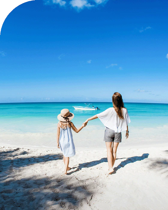 A family strolls on the beach in St. Thomas, Caribbean.