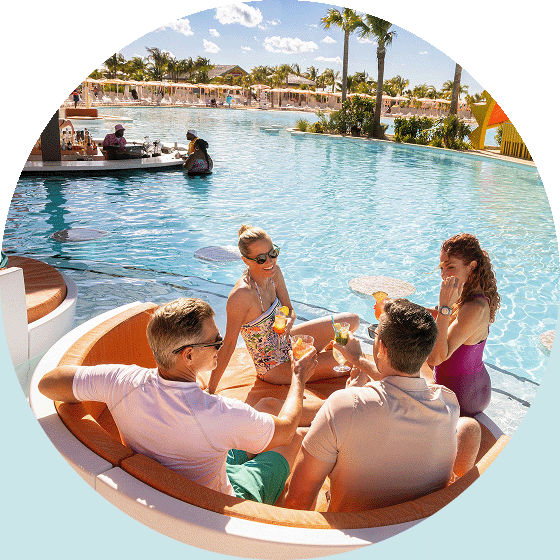A group of friends enjoy poolside drinks.