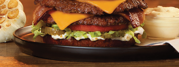 Fresh beef, real Wisconsin Cheddar Cheese, thick-cut bacon, creamy garlic mayo, crisp dill pickles, lettuce and tomato on a Garlic Herb Pretzel Bun - this burger is a midwest masterpiece.