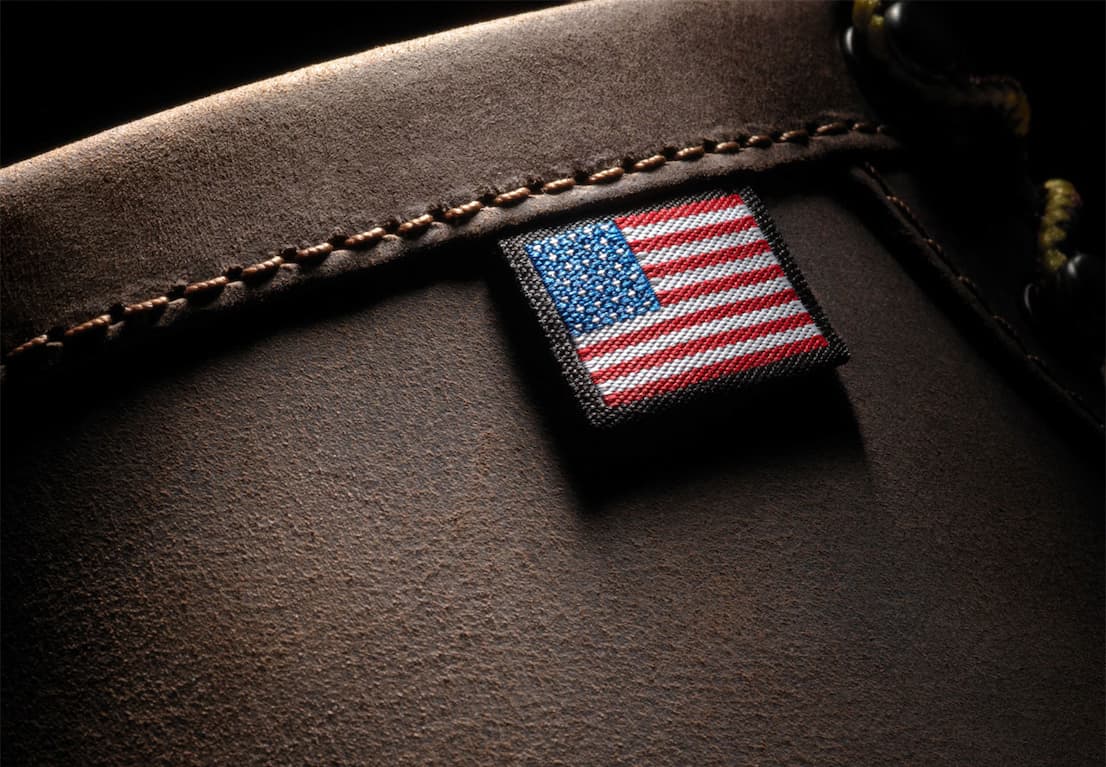 Close-up of brown leather on a Danner Bull Run work boot featuring a stitched American flag tag.
