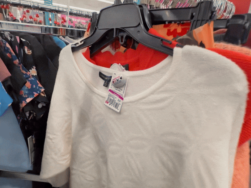Gif with cream colored floral sweater, orange knit long sleeve and dark orange short sleeve sweater. sweater