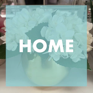 Gold round vase with white flowers with a teal overlay that says 