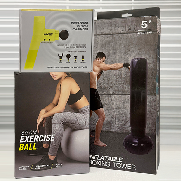 Retail boxes displaying a percussion muscle massager, a 65 cm exercise ball, and a five-foot inflatable boxing tower.