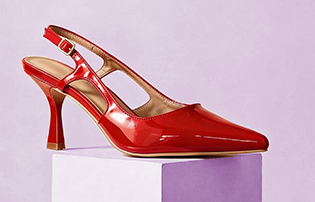 A glossy red slingback pump with a pointed toe and mid-height heel, shown on a white display block.