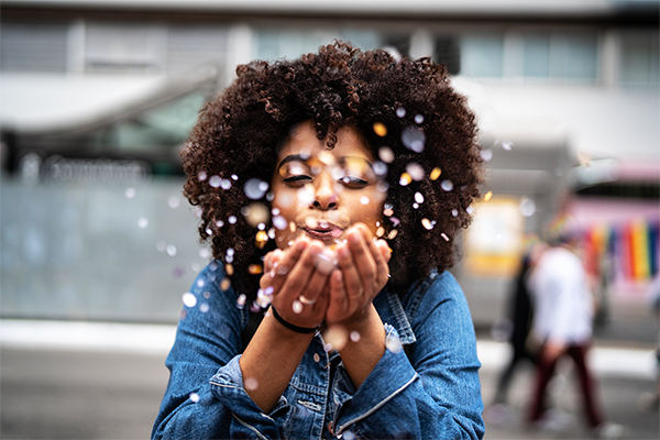 Women Blowing Confetti