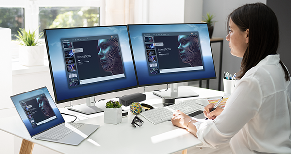 Graphic Designer Artist Working On Multiple Computer Screens