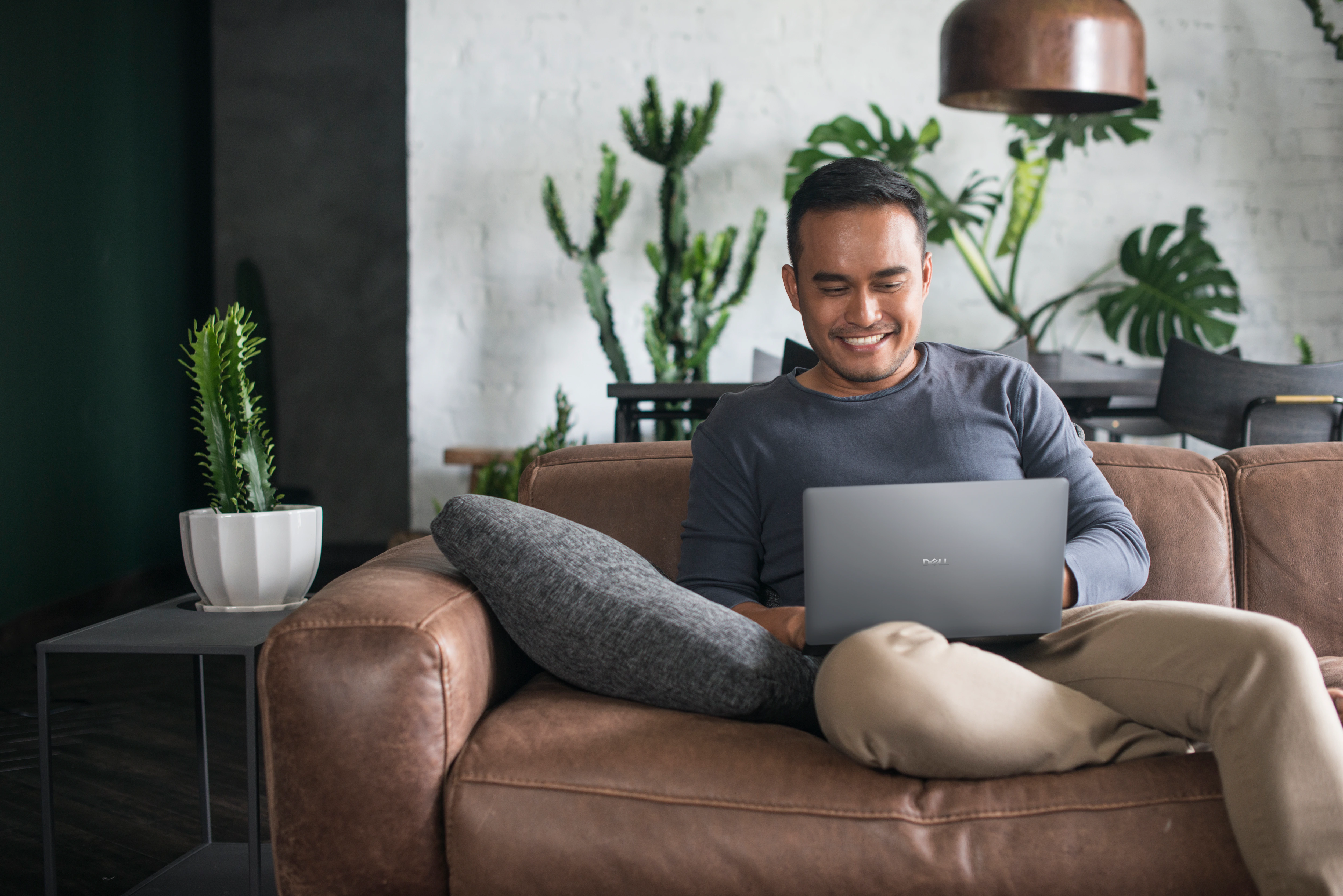 Young man using the laptop in the living room.