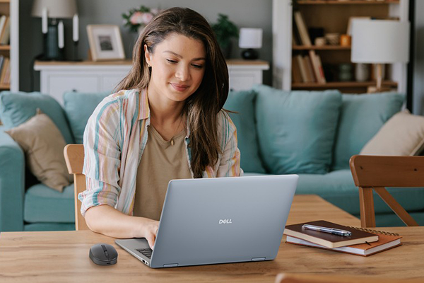 A person enjoying working from home on a Dell laptop. 