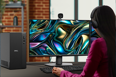 Over-shoulder view of a woman working on a Dell                               Tower Desktop computer in an office setting.