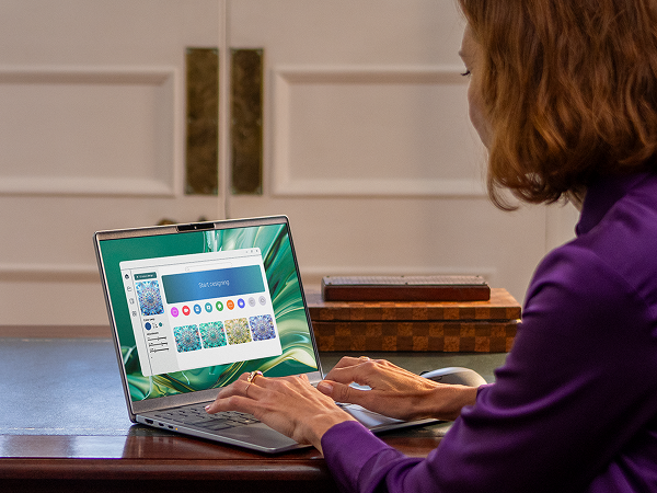 An over-shoulder view of a person creating a beautiful design on their Dell laptop computer.