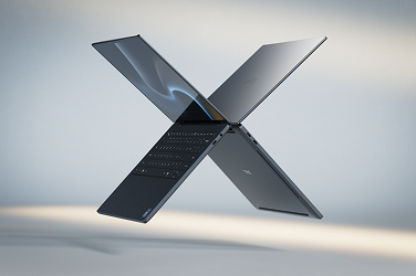 Two Dell XPS laptop computers floating in midair in the shape of the letter “X”.