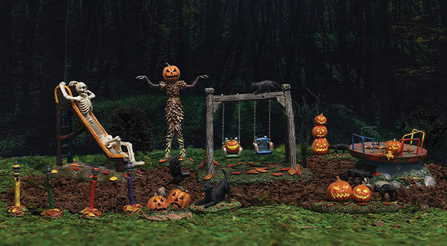 Halloween Village playground with skeletons on swings and slides.