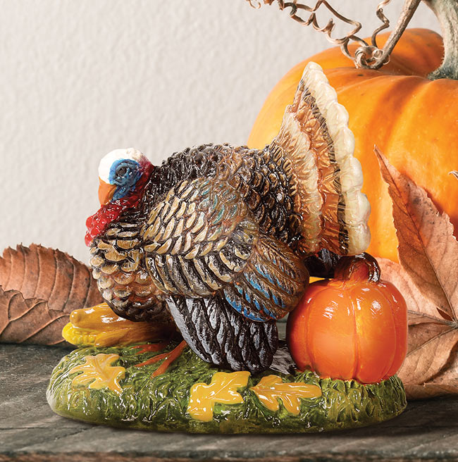 Turkey figurine with pumpkin and fall leaves