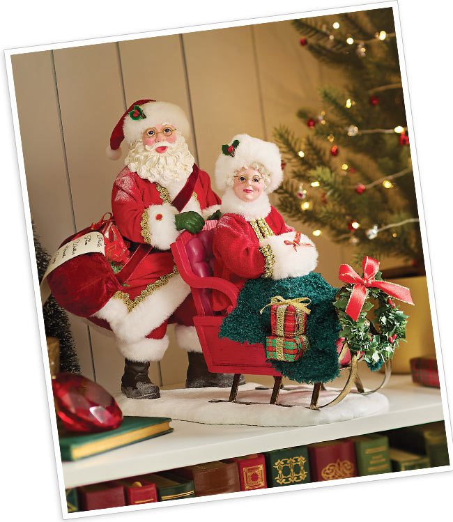 Ruby red accents on Santa's fur cuffs, Mrs. Claus's fur collar and muff.