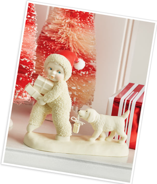 Helpful puppy trails the Snowbaby, scooping up any parcels that may fall.