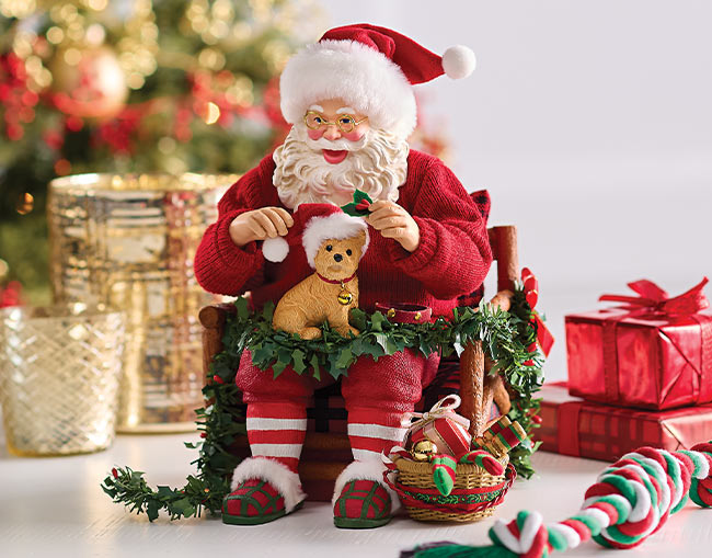 Santa cuddling puppy in festive chair