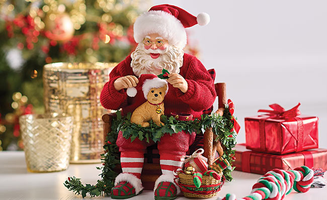 Santa cuddling puppy in festive chair