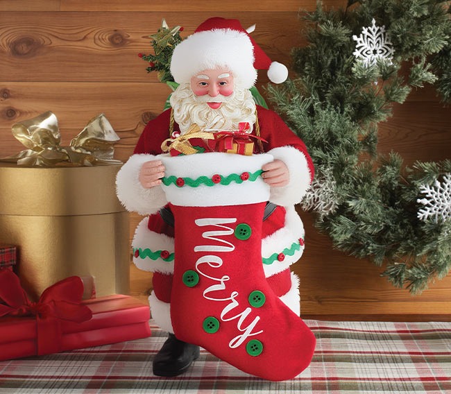 Santa holds a festive “Merry” stocking filled with gifts.