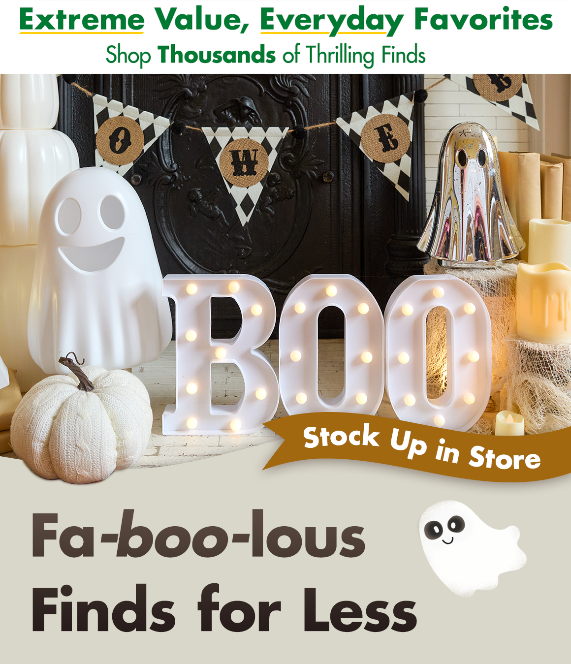 Halloween decorations including ghosts, pumpkins, candles, and a sign that says BOO in front of a fireplace