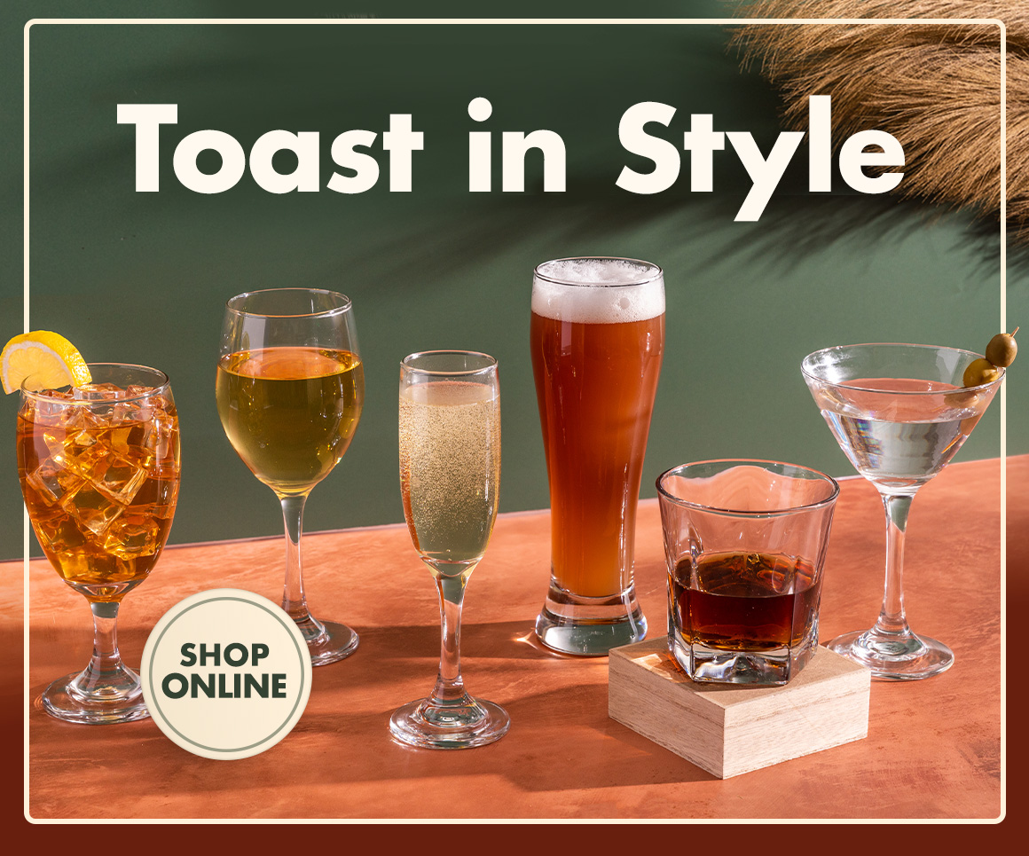 Image of glassware for different drinks arranged on a table under a headline saying " Toast in Style "