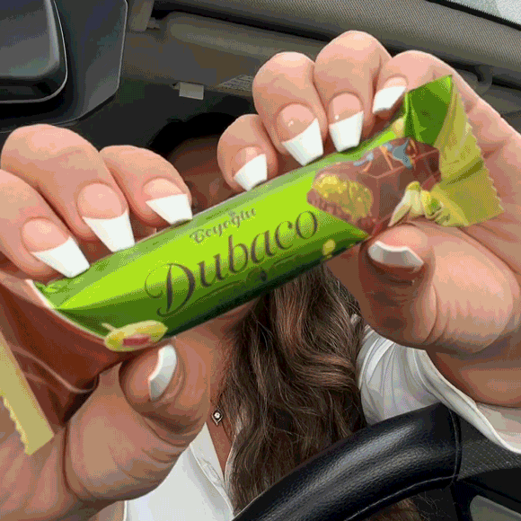 Video showing a woman in her car opening and enjoying Dollar Tree's new Dubai Chocolate. Click to watch video on Instagram.