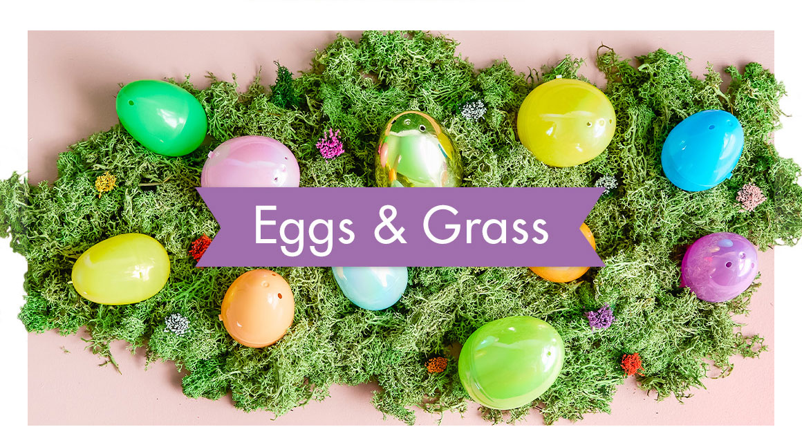 Image of an assortment of Easter eggs laid out on a table of grassy moss with a headline saying “Eggs & Grass"