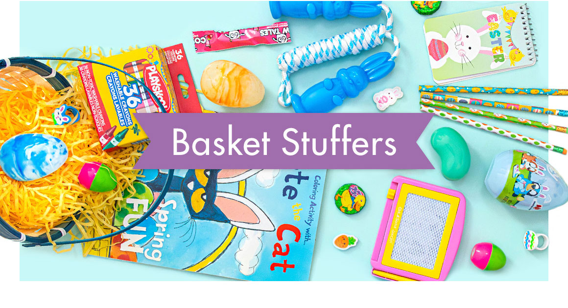 Image of a basket spilled over with an assortment of candy toys, eggs, and grass falling out of it with a headline saying “Basket Stuffers”