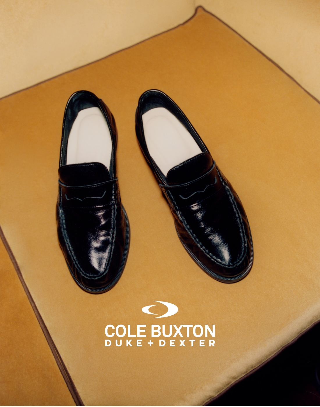 an image of a pair of black shoes sitting on a sofa