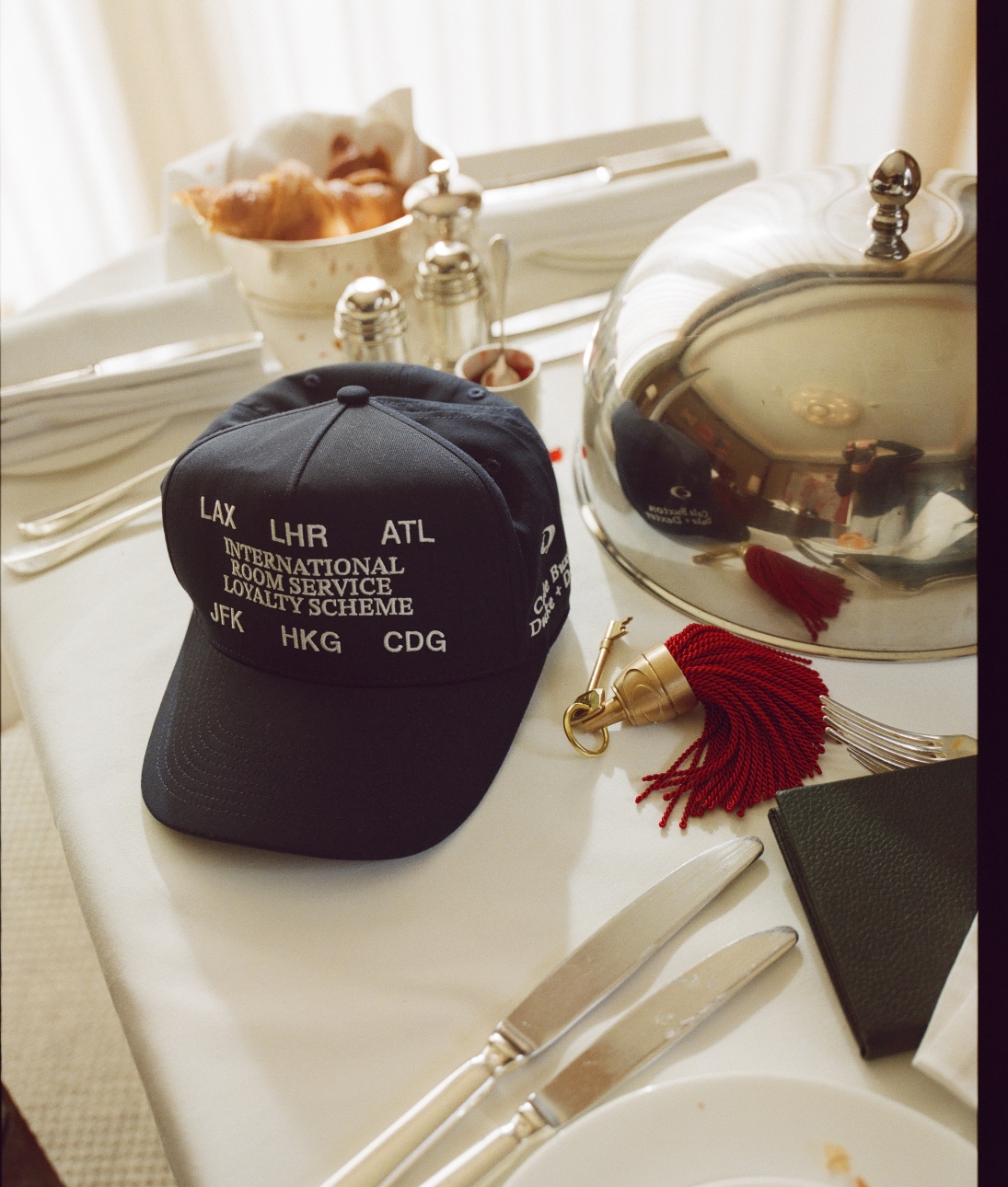 an image of a hat sitting on top of a table next to a silver platter