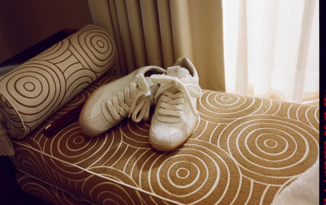 an image of a pair of white shoes sitting on a sofa