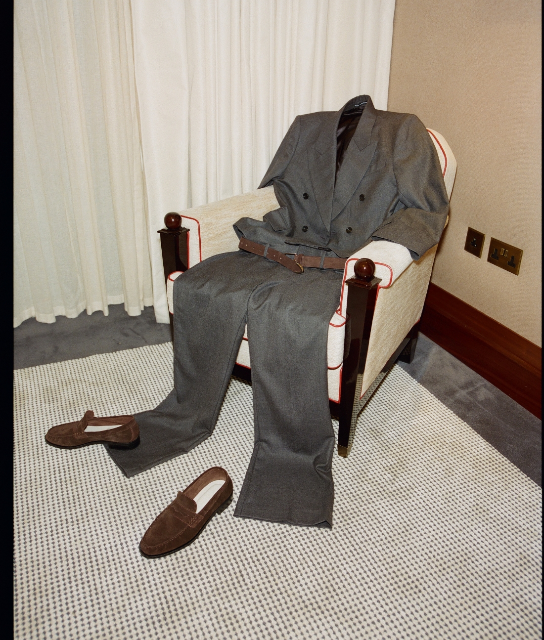an image of a suit and shoes are sitting on a chair