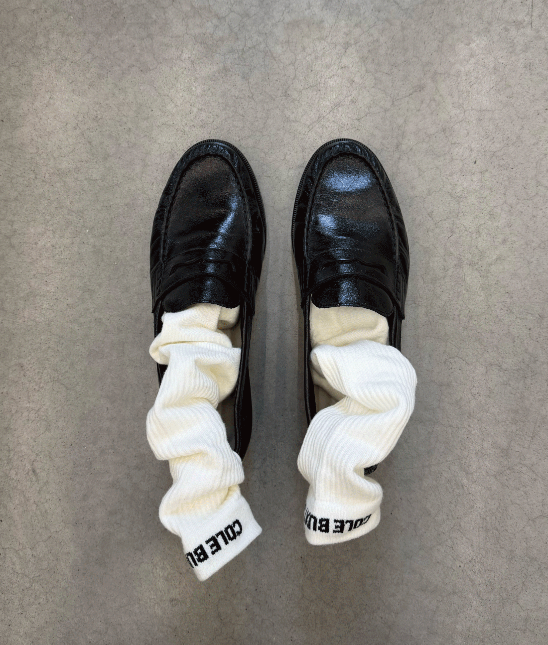 an image of a pair of black shoes with white socks