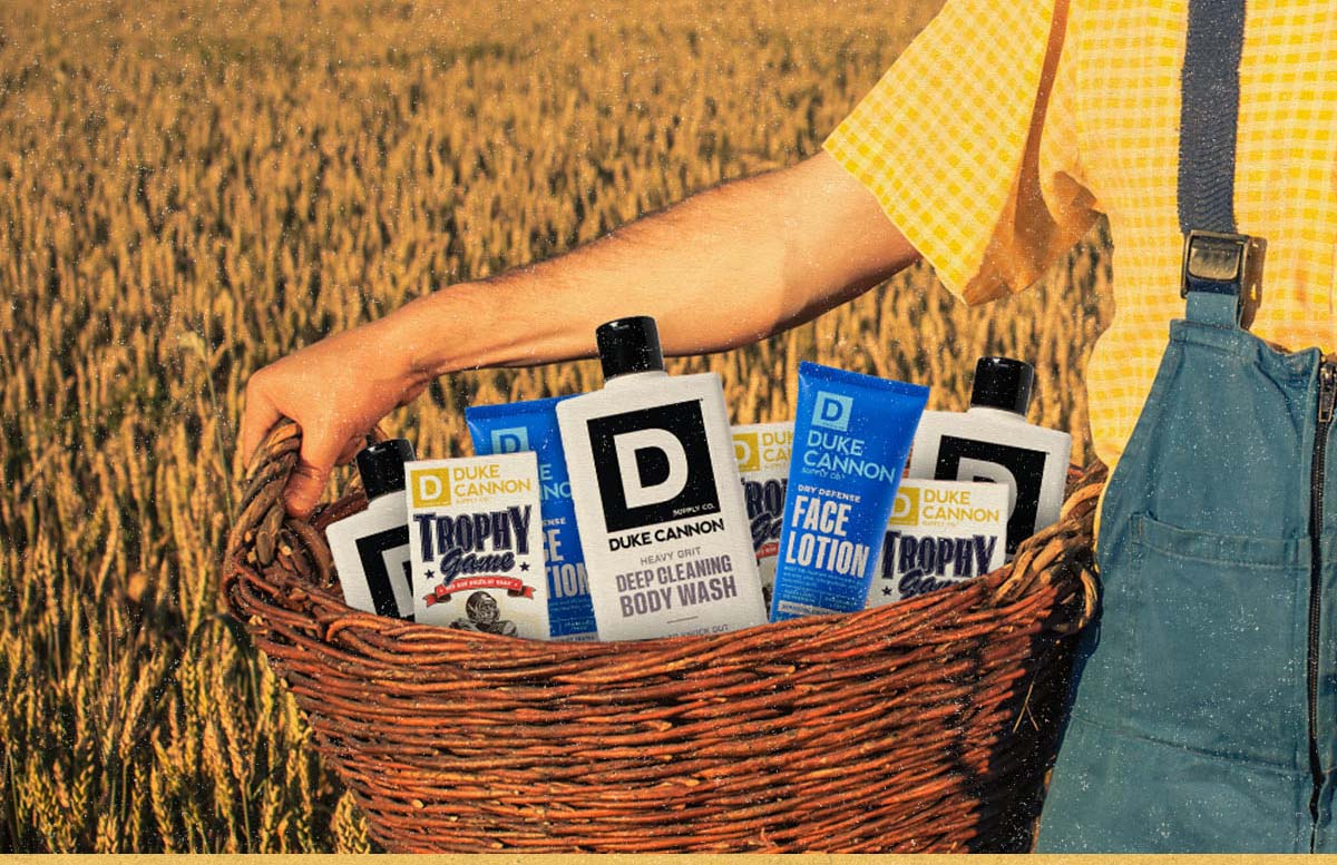 Basket full of Duke Cannon products. Deep cleaning body wash, trophy game Brick, Dry Defense Face Lotion.