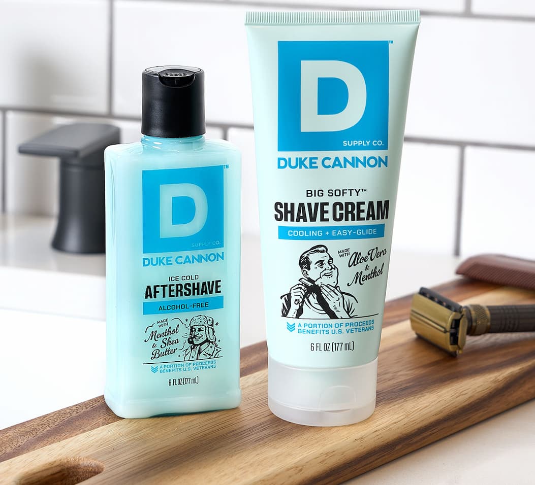 After Shave and Shaving Cream from Duke Cannon on a counter top next to a razor.