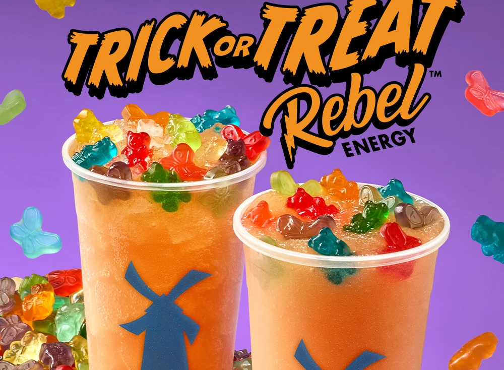 Trick or Treat Rebel Energy | Two icy orange drinks with gummy candies on top pictured against a purple background